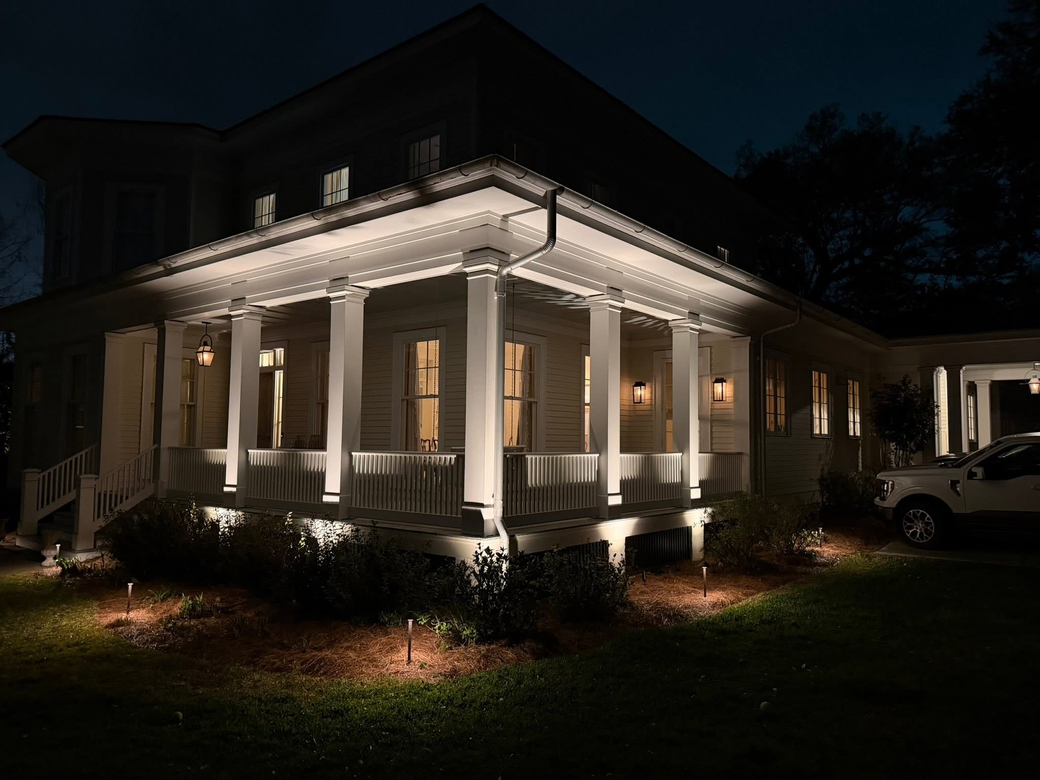 Wraparound porch with soffit and bed lighting